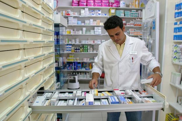 Un profesional prepara medicamentos en una farmacia valenciana. 