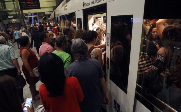 Personas suben al metro en Valencia.