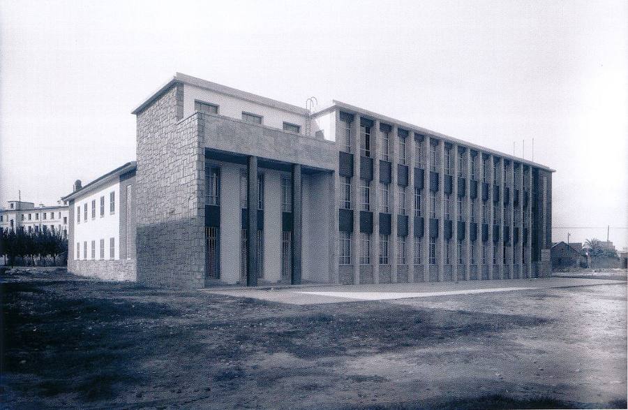 Escuela de Flechas Navales | A finales de 1956, se autoriza al llamado 'Frente de Juventudes del Distrito Universitario de Valencia del Cid' a ocupar los terrenos de la Junta de Obras del Puerto de Valencia, en la zona de servicios, para construir la citada escuela. Inaugurado por Francisco Franco, el edificio vio pasar por sus aulas a muchas generaciones de alumnos hasta que fue derribado hace más de una década para dar lugar al circuito urbano de Fórmula 1. Gran parte de su alumnado pasó al Instituto de Educación Básica Baleares. -Foto Sanchis. Arxiu Generalitat. Libro 'La Valencia desconocida'-.