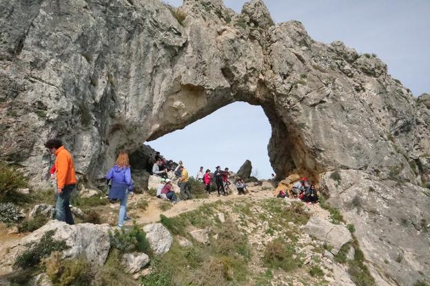 Decenas de turistas disfrutan del buen tiempo y de la vistas de la Vall de Gallinera desde la 'Forada'. 