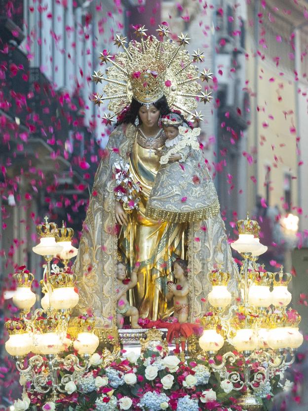 Lluvia de pétalos al paso de la patrona. 