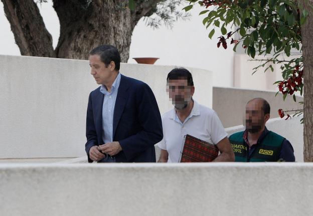 Zaplana, seguido por un policía, durante el registro de su chalé en Benidorm. 