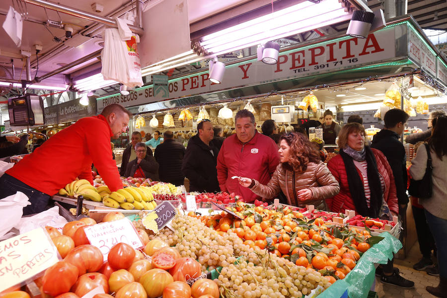 Lleno hasta la bandera. Así ha estado este sábado el centro de Valencia con curiosos que querían fotografiar todos los escaparates, pero sobre todo con gente haciendo las compras de Nochevieja. Uno de los puntos de encuentro que ha registrado el cartel de 'completo' ha sido una vez más el Mercado Central. El marisco, salazones, frutos secos y quesos variados llenan las cestas a dos días del Fin de Año. 