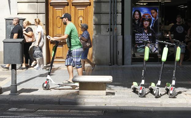 Un usuario de patinete, por una acera en Valencia.