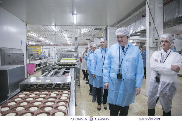 Rafael Juan con Ximo Puig, Diana Morant y Lorena Milvaques observando la producción de ensaimadas. 