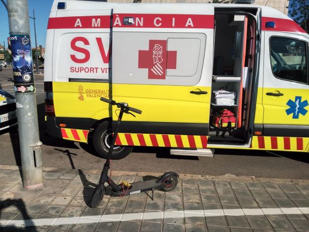 Un patinete junto a una ambulancia en una calle de Valencia. 