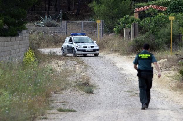 Un guardia civil camina por una zona de Llíria donde se halló el cuerpo de una desaparecida. 