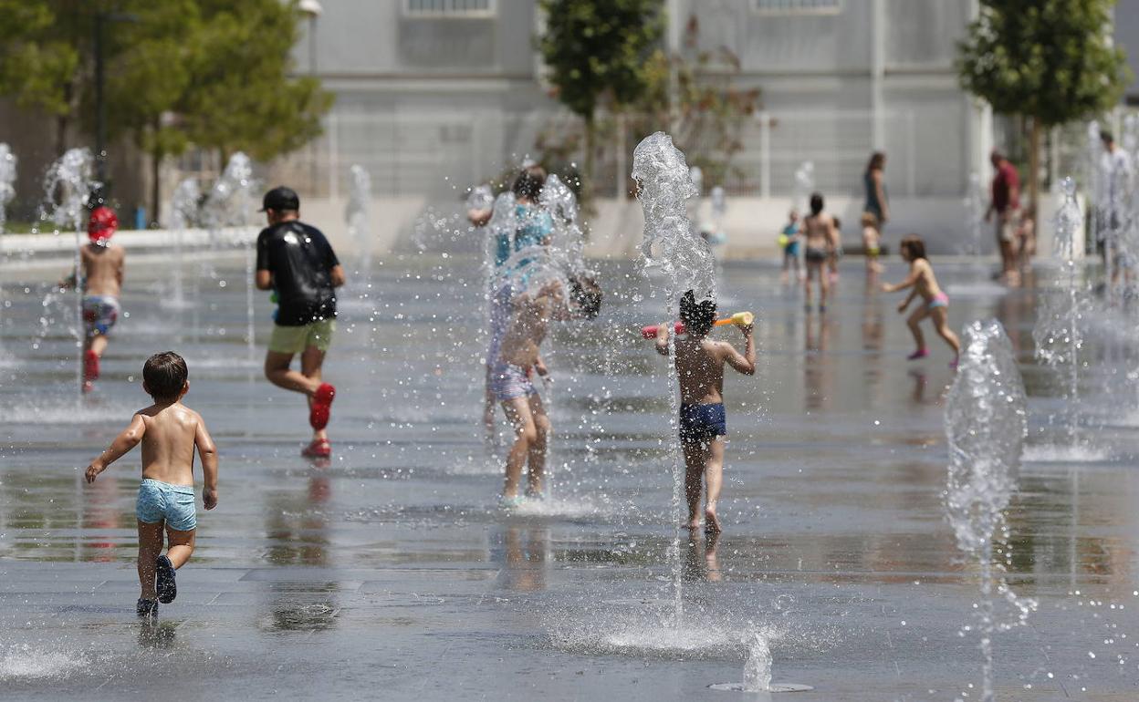 Unos niños se refrescan en las fuentes de un parque a principios de julio. 