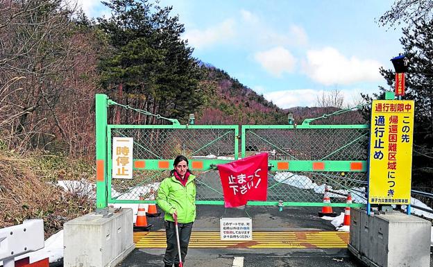 Imagen principal - La primera foto, Raquel Montón (Greenpeace) mide la radiactividad ante la zona de exclusión. Abajo, el guía de Akihiro Yoshiikawa. última imagen, un turista japoneés retrata el lugar. 