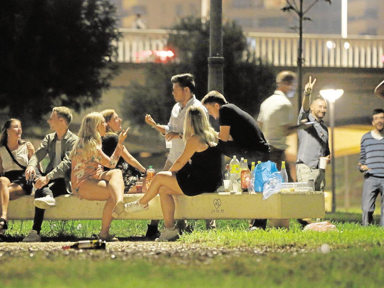 Un grupo de jóvenes hace botellón en el río cerca de la Ciudad de las Artes. 