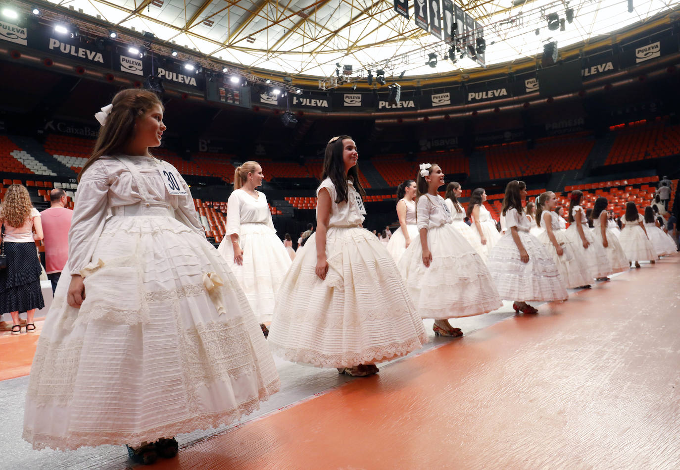 El pabellón de la Fonteta acogió ayer una jornada de ensayo de las 73 candidatas mayores y 73 niñas que optan a formar parte de las cortes de honor de 2020. Todas ellas tomaron asiento en las gradas y, posteriormente, desfilaron de forma ordenada con el número que las identifica ante la atenta mirada de los jurados, que estaban tomando buena nota de la puesta en escena. Con las habituales enaguas de la indumentaria valenciana y con una blusa o chaqueta y con los zapatos de valenciana, todas ellas mostraron su mejor sonrisa y no dudaron en aflorar los nervios típicos antes de la gala del sábado. La escuela de danza de Susana Renau y los falleros que colaborarán en el espectáculo también repasaron los números.