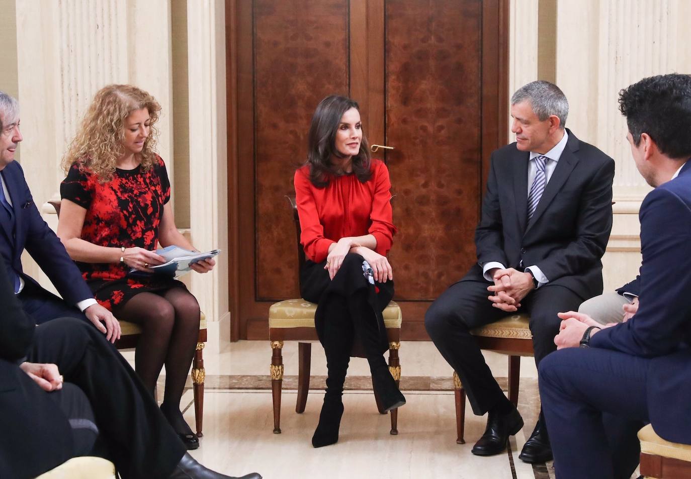 La Reina ha tenido el primer acto de su agenda oficial de esta semana, durante la mañana de este martes, recibiendo audiencias en el Palacio de la Zarzuela. Doña Letizia primero se ha reunido con FEDICINE, la Federación de Distribuidores Cinematográficos y, acto seguido, con la Fundación Mujeres. Para los actos ha optado por el mismo look recuperando antiguas piezas de su armario: una blusa roja de Hugo Boss, falda negra midi de flores estampadas de Carolina Herra combinandola con calzado alto de Magrit.