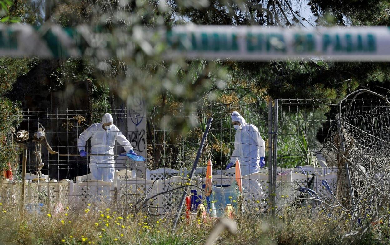 Dos guardias civiles del Laboratorio de Criminalística inspeccionan la piscina. 