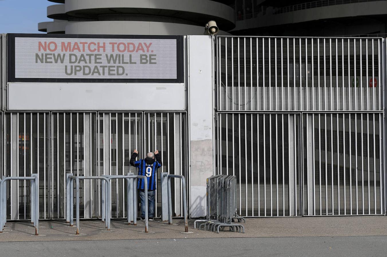 Un hombre se encuentra fuera del estadio de San Siro después de que el partido Inter de Milán-Sampdoria de la Serie A fuera cancelado debido al brote del coronavirus en Lombardía y Véneto.