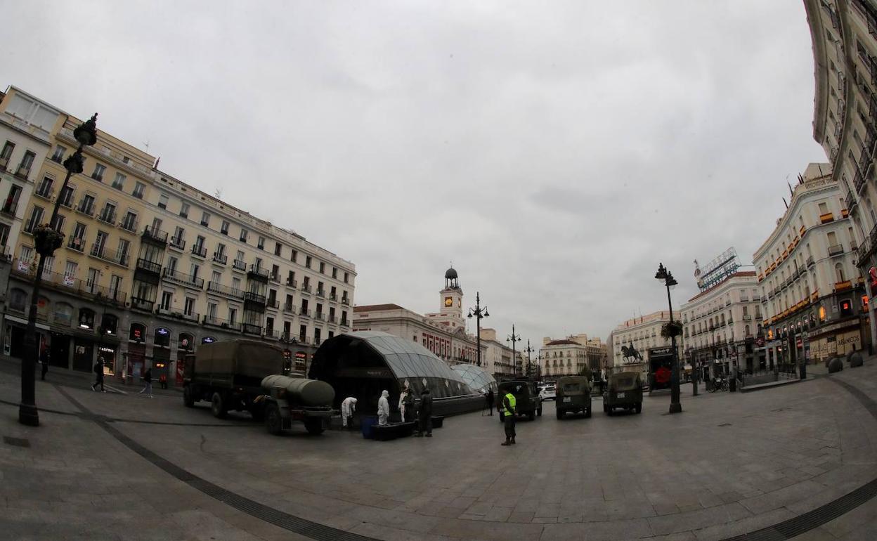 Efectivos de la UME desinfectan la Puerta del Sol de Madrid.