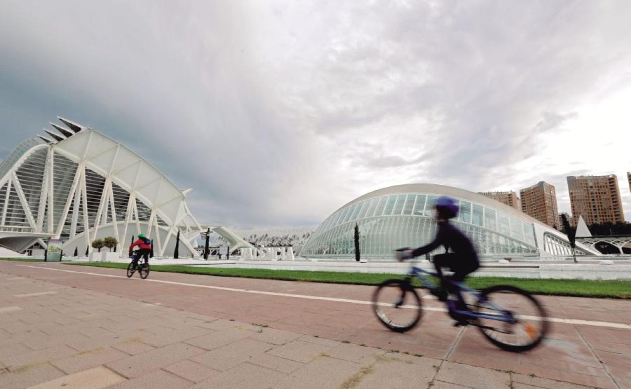 Un niño, en bicicleta, por la Ciudad de las Artes y de las Ciencias.