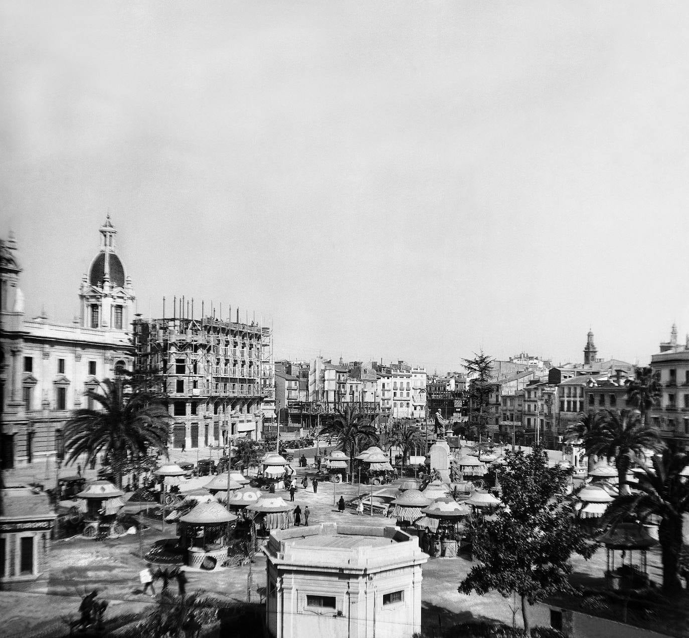 1920. Hace un siglo la plaza aún no era como hoy es, arquitectónicamente hablando. Quioscos en el centro, junto con una estatua central y edificios hoy icónicos aún por construir o en construcción.