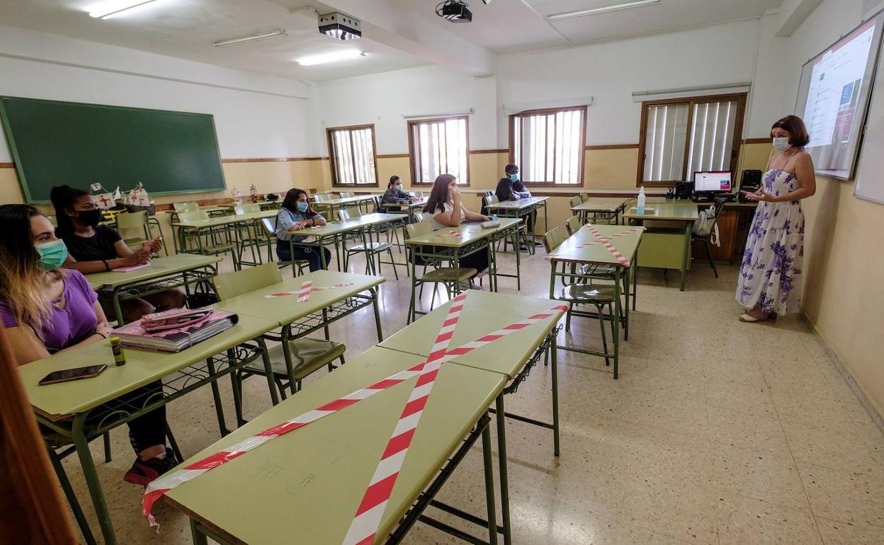 Alumnos en clase con mascarilla y guardando distancias. 