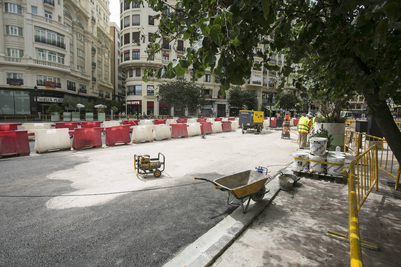 En la zona próxima a la calle Barcelonina, como se observa en la imagen, la contrata de asfaltado ha comenzado ya a aplicar el acabado del nuevo pavimento de la plaza del Ayuntamiento, que quedará de color rojizo para igualarlo con las aceras y distinguir las nuevas zonas peatonales de la parte que quedará abiertas al tráfico. La última capa será una resina antideslizante que además ayudará a fijar el tono con el pulimentado de los áridos mezclados con el aglomerado.