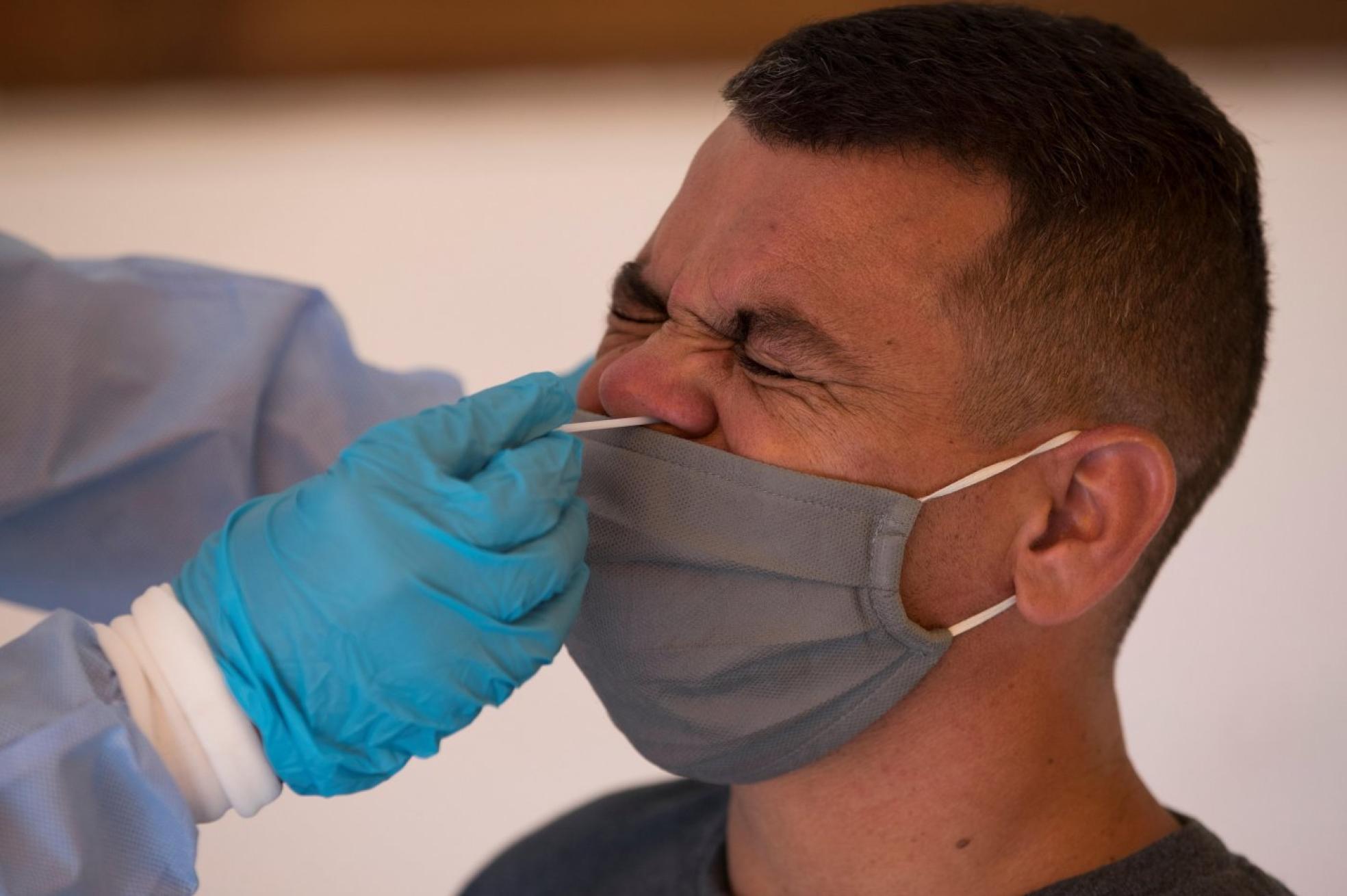 Un sanitario realiza una prueba PCR a un hombre para comprobar un contagio. efe