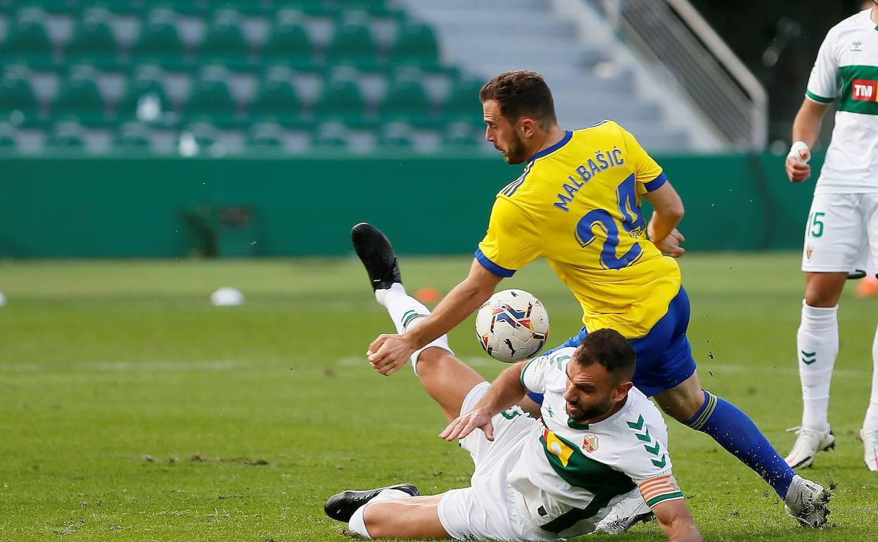 Gonzalo Verdú y Malabasic pugnan por un balón en el Elche-Cádiz del pasado sábado. 