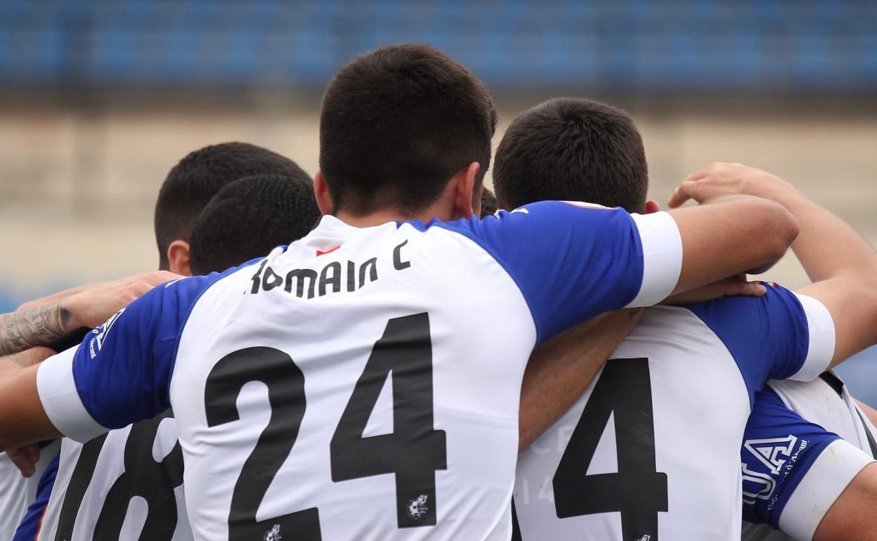 Los jugadores del Hércules abrazan a Benja tras anotar el tanto de la victoria. 