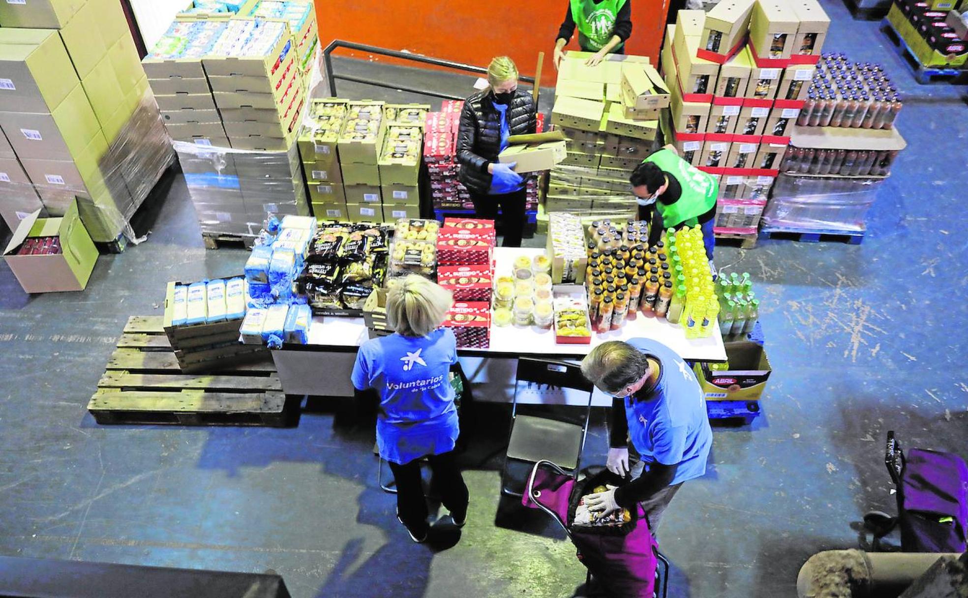 Ayuda. Voluntarios del Banco de Alimentos reparten paquetes.