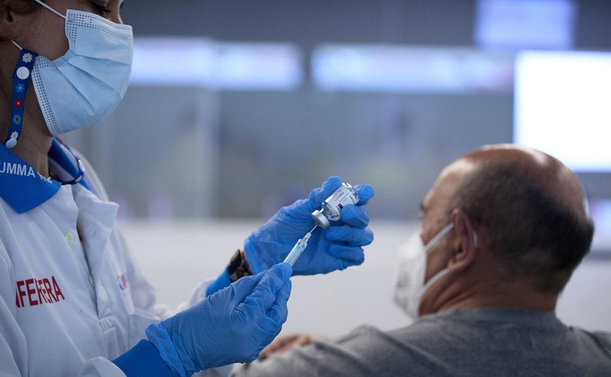 Un sanitario prepara una vacuna. 