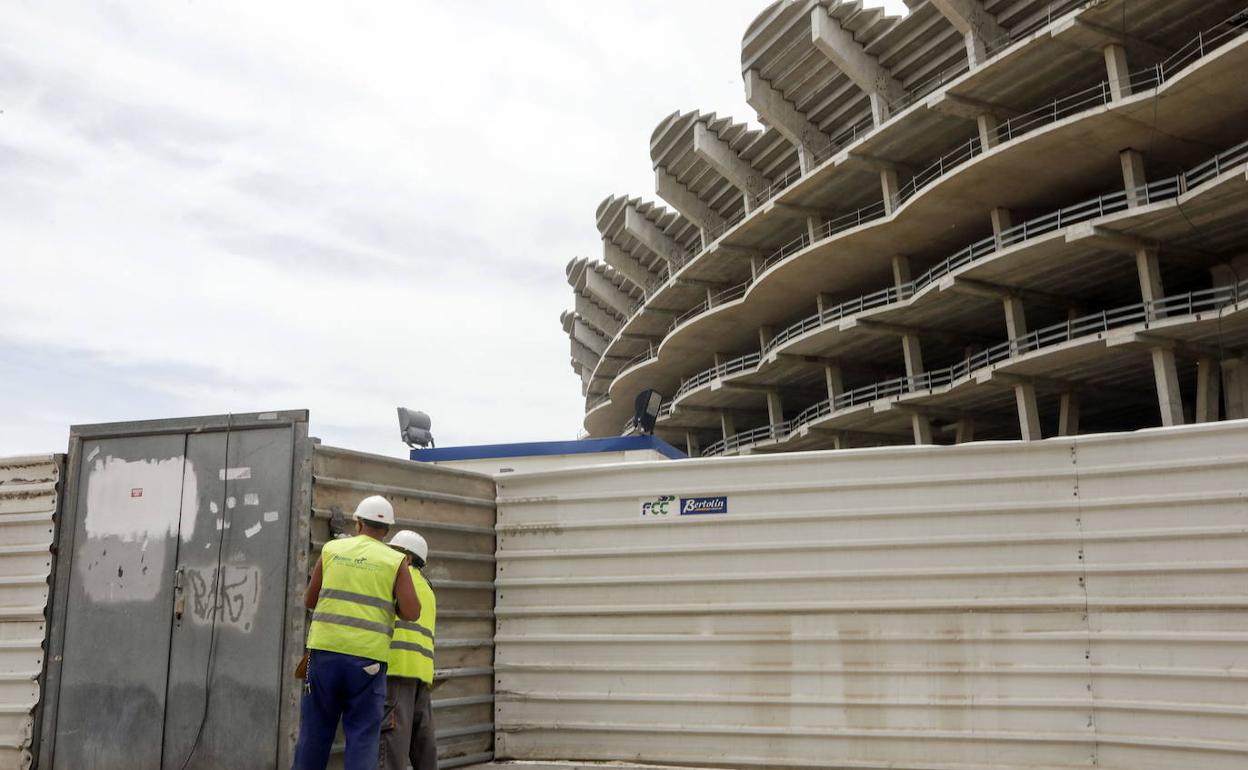 Dos operarios, junto al nuevo Mestalla. 