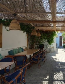 Imagen secundaria 2 - Arriba, la terraza exterior del restaurante La Chipirona Playa. Abajo a la izquierda, barra del patio interior. Abajo a la derecha, mesas de la terraza interior.