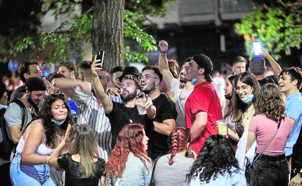 Jóvenes hacen botellón en la plaza de Honduras, en Valencia. 