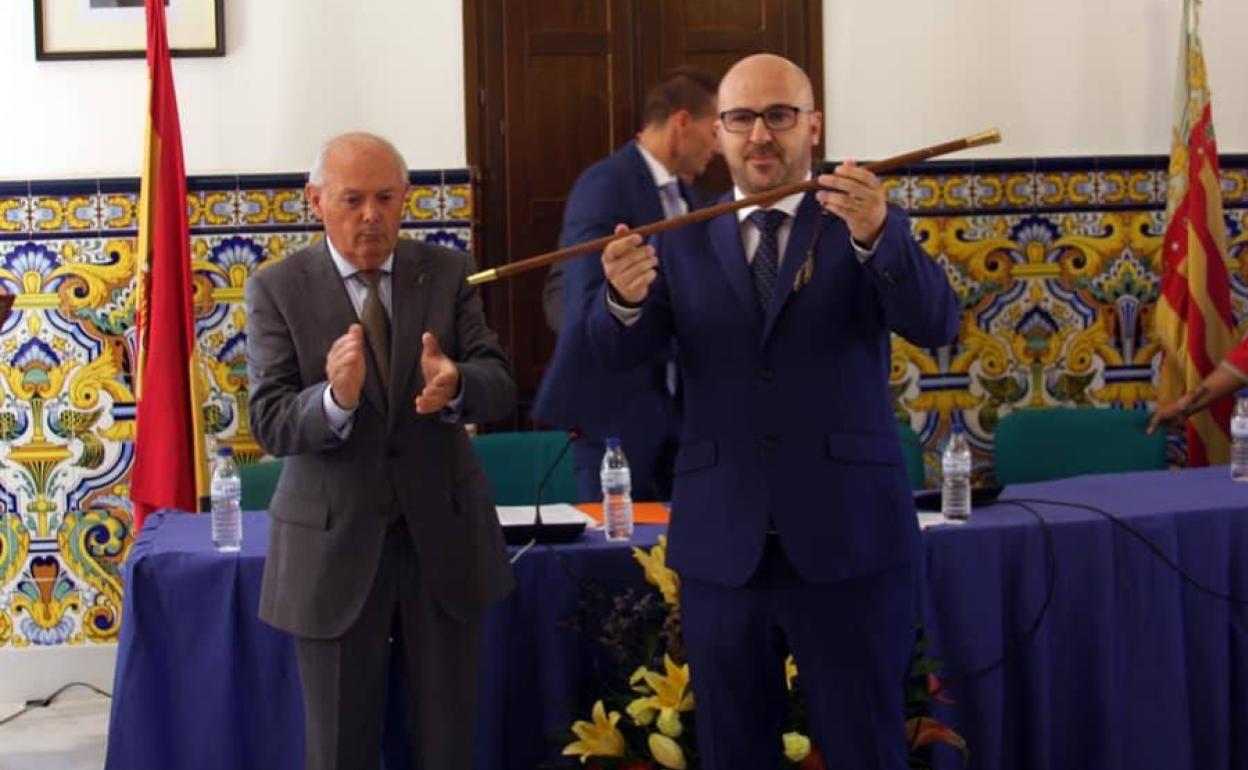 El alcalde, Guillermo José, alza la vara de mando, junto a sus próximo sustituto, Agustín Aliaga. 