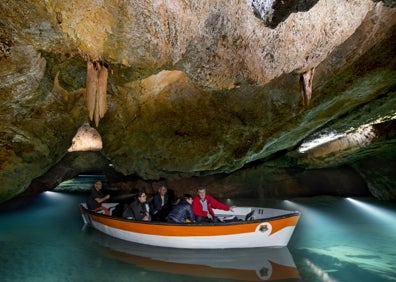 Imagen secundaria 1 - Arriba, una de las salas de las cuevas. Abajo a la izquierda, un barquero guía a los visitantes a través de las grutas. Abajo a la derecha, una columna de las cuevas. 