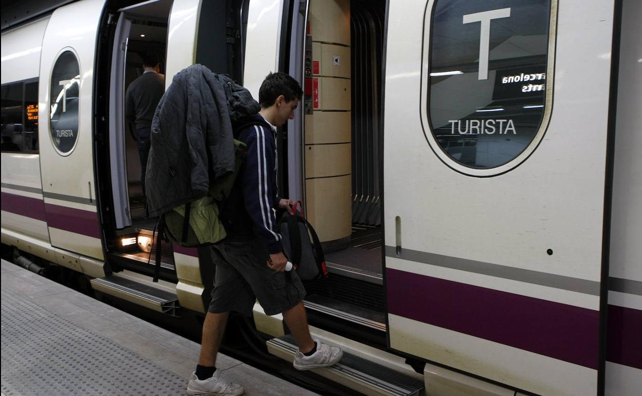 Un joven sube a un tren. 