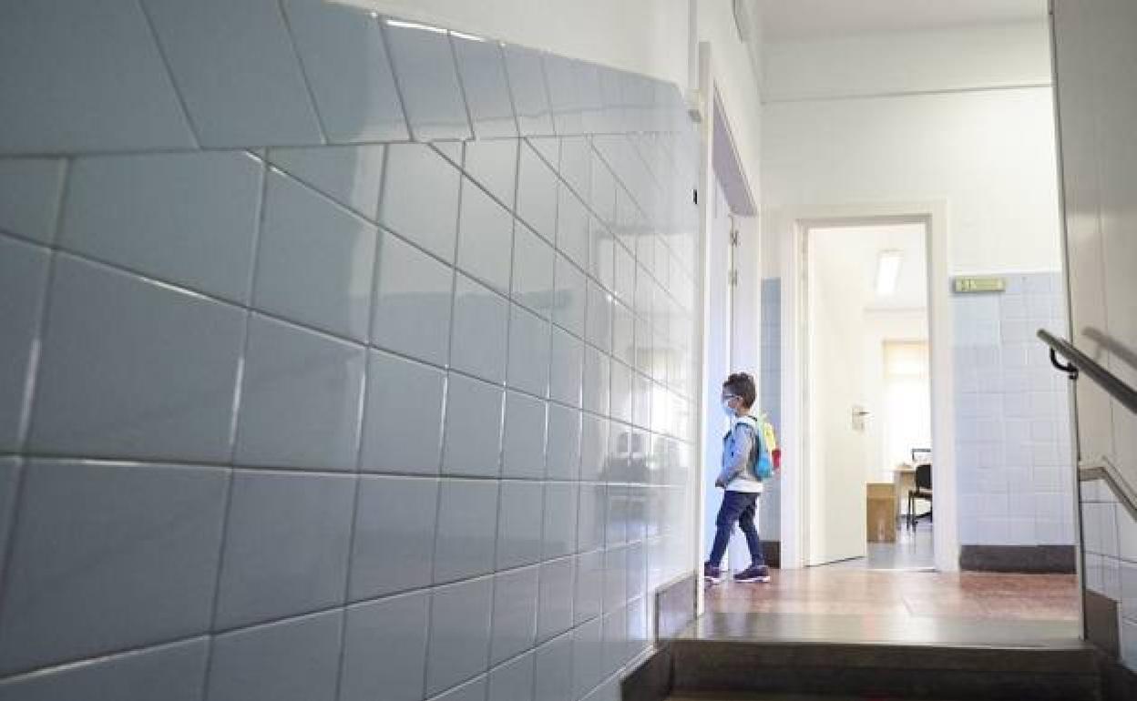 Un alumno entrando en su clase en el primer día de colegio.