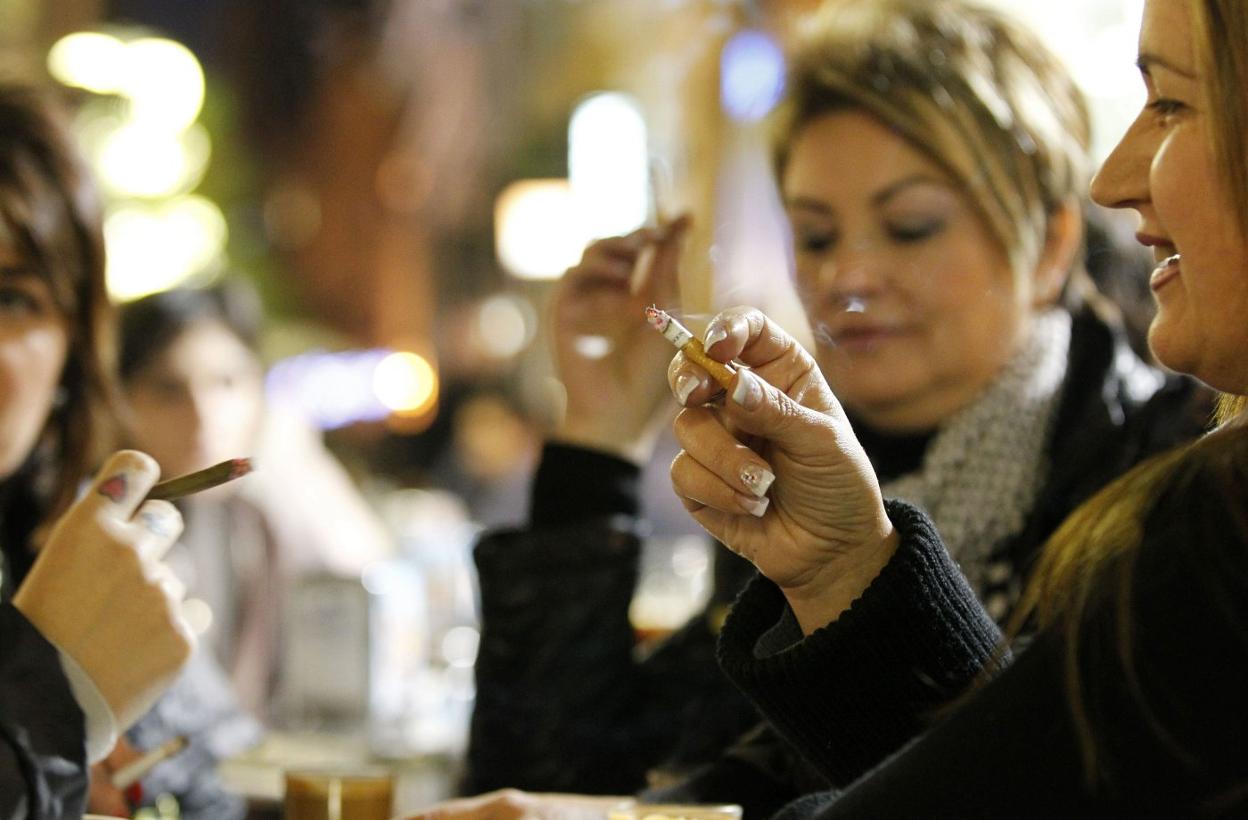 Dos mujeres fuman en la terraza de un local de Valencia. jesús signes