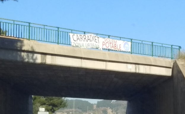 Pancarta instalada por los vecinos del Carraixet en el acceso a Xàtiva por la CV-41. 