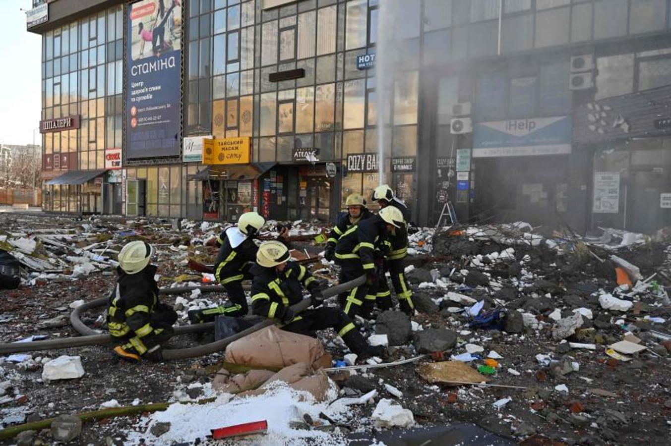 Los bomberos trabajan en las labores de rescate después de que un misil impactara contra un edificio residencial.