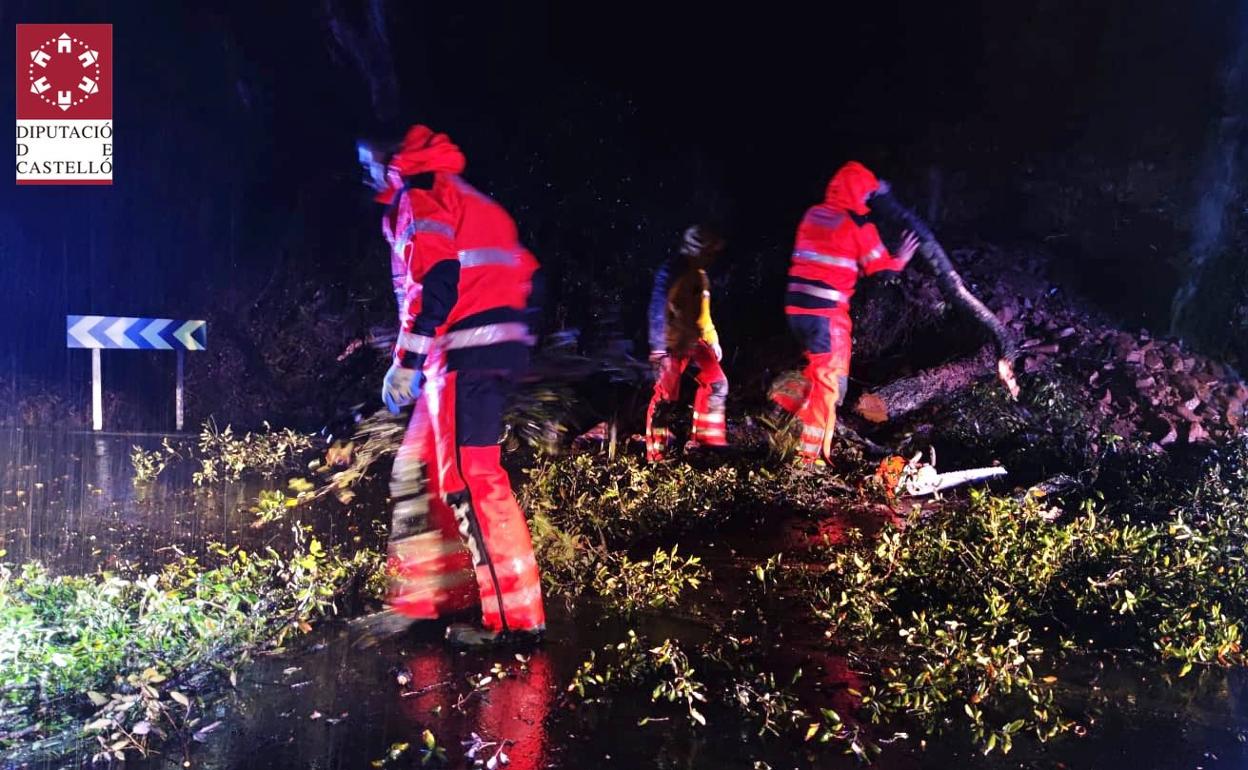 Efectivos de Bomberos retiran restos de árboles que han cortado la carretera entre Eslida y Artana. 