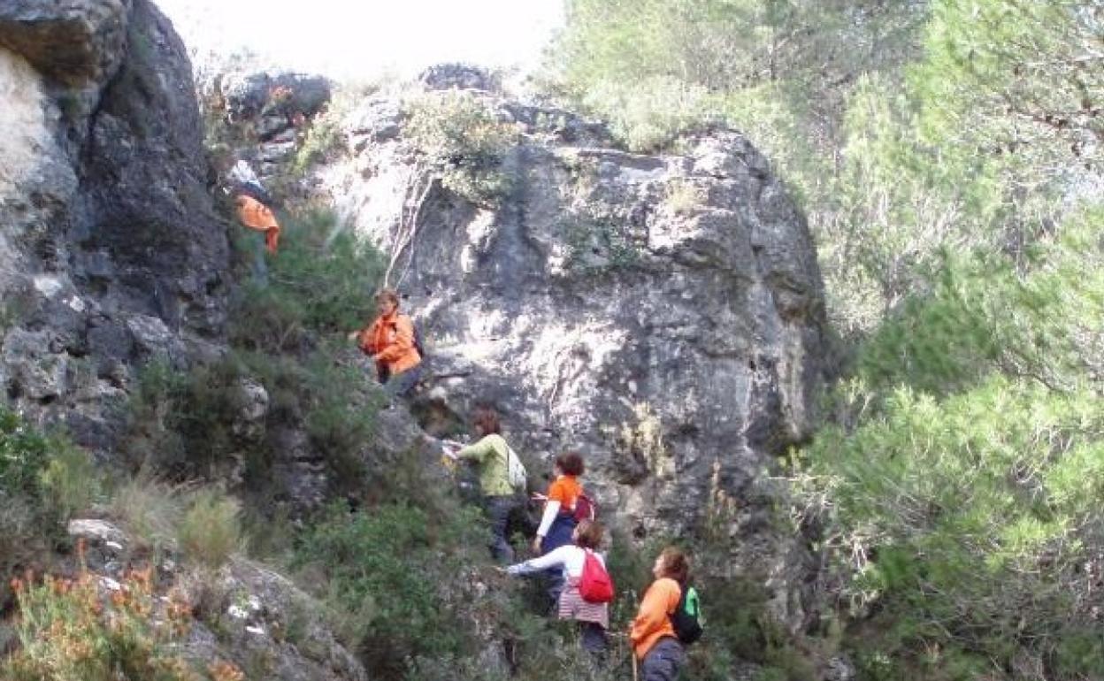 Excursionistas realizando la ruta del Pico del Fraile en el término de Bicorp. 