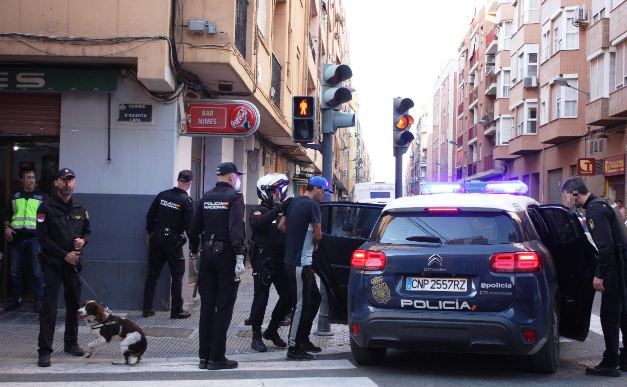 Uno de los detenidos sube al coche patrulla de la Policía Nacional. 