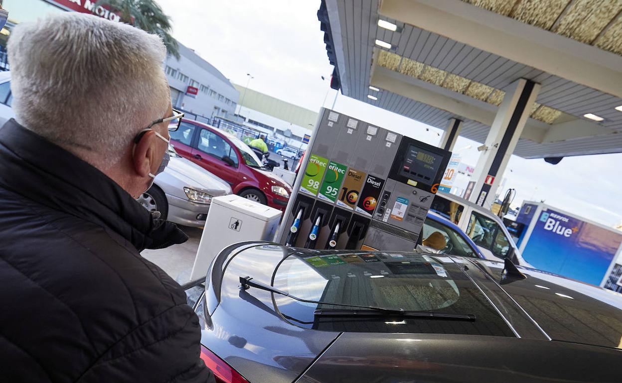 Un hombre reposta en una gasolinera. 