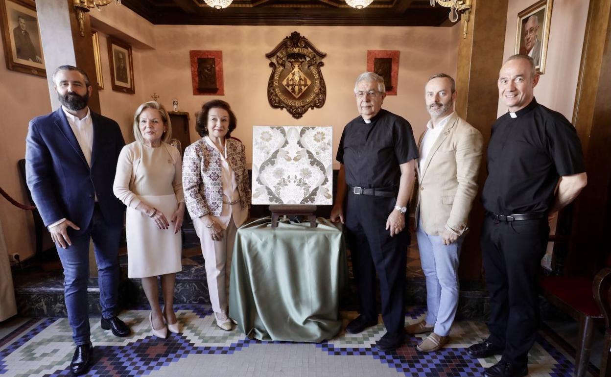 Responsables del Gremio de Sastres y de la Basílica de Valencia, junto a la muestra de la tela de espolín que se tejerá para un manto de la Virgen.