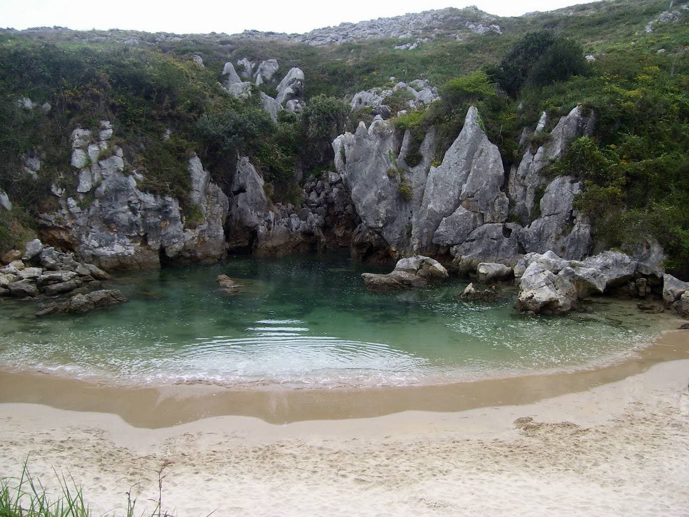 8.- Gulpiyuri (Asturias) | Playa pequeña pero con una belleza de enormes proporciones. Cuenta con sólo cinco metros de longitud y ha sido declarada como monumento natural. Tiene la ventaja de que no se puede acceder a ella en coche, lo que hace que no se produzcan aglomeraciones. Tiene la peculiaridad de que el agua llega a través de un túnel entre las rocas, por lo que la profundidad de su agua es más bien escasa.