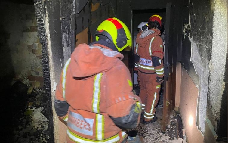 Bomberos en la vivienda incendiada.