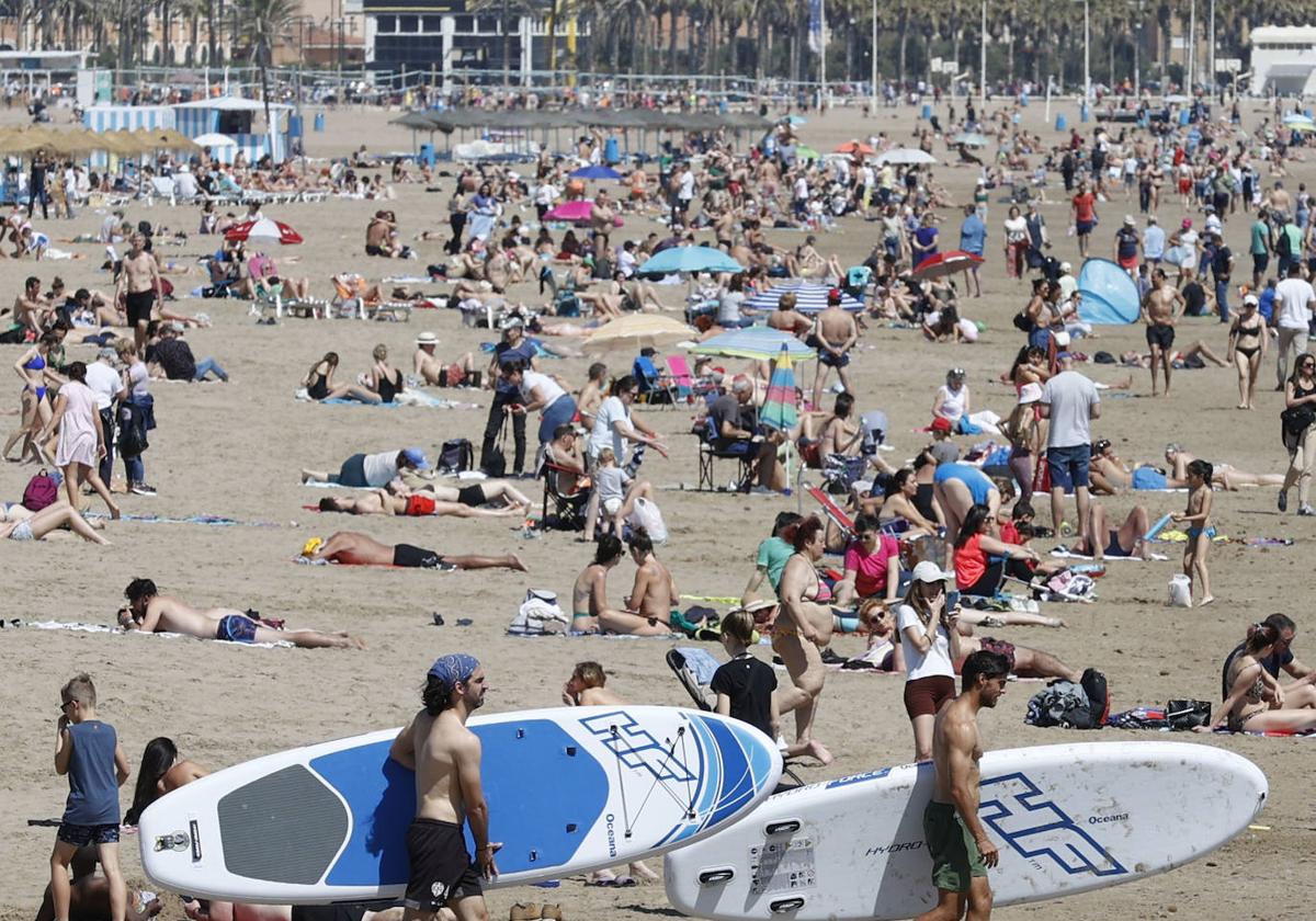 Valencianos y visitantes se lanzan a la playa ante las altas temperatuas.