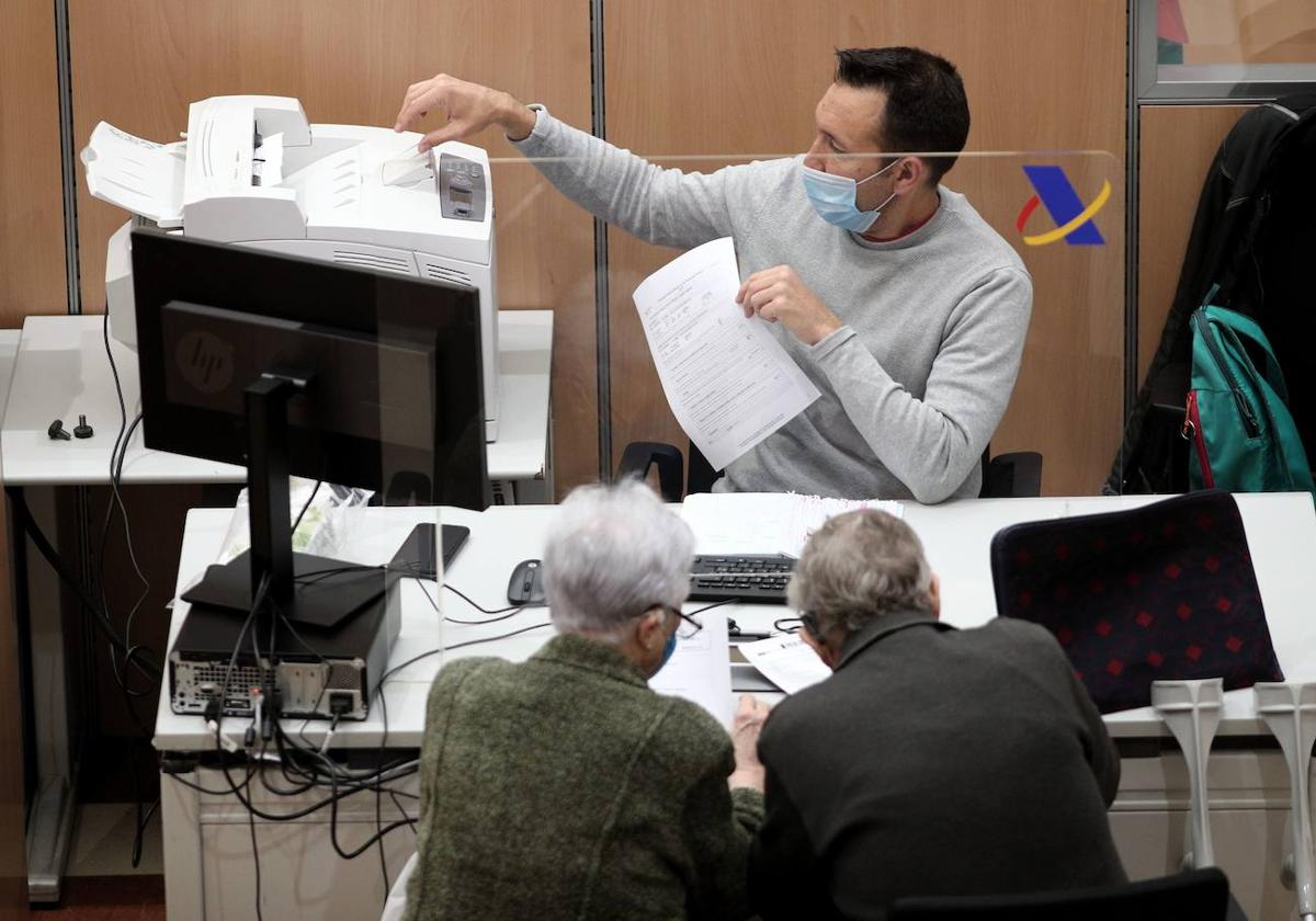 Dos personas presentan la declaración de la Renta en una oficina de la Agencia Tributaria.