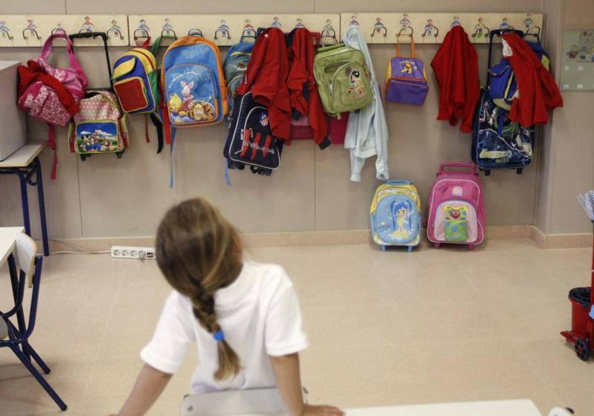 Una niña en el aula de un colegio.