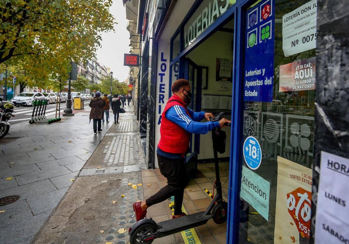 Un jugador entra a una administración de Loterías y Apuestas del Estado.