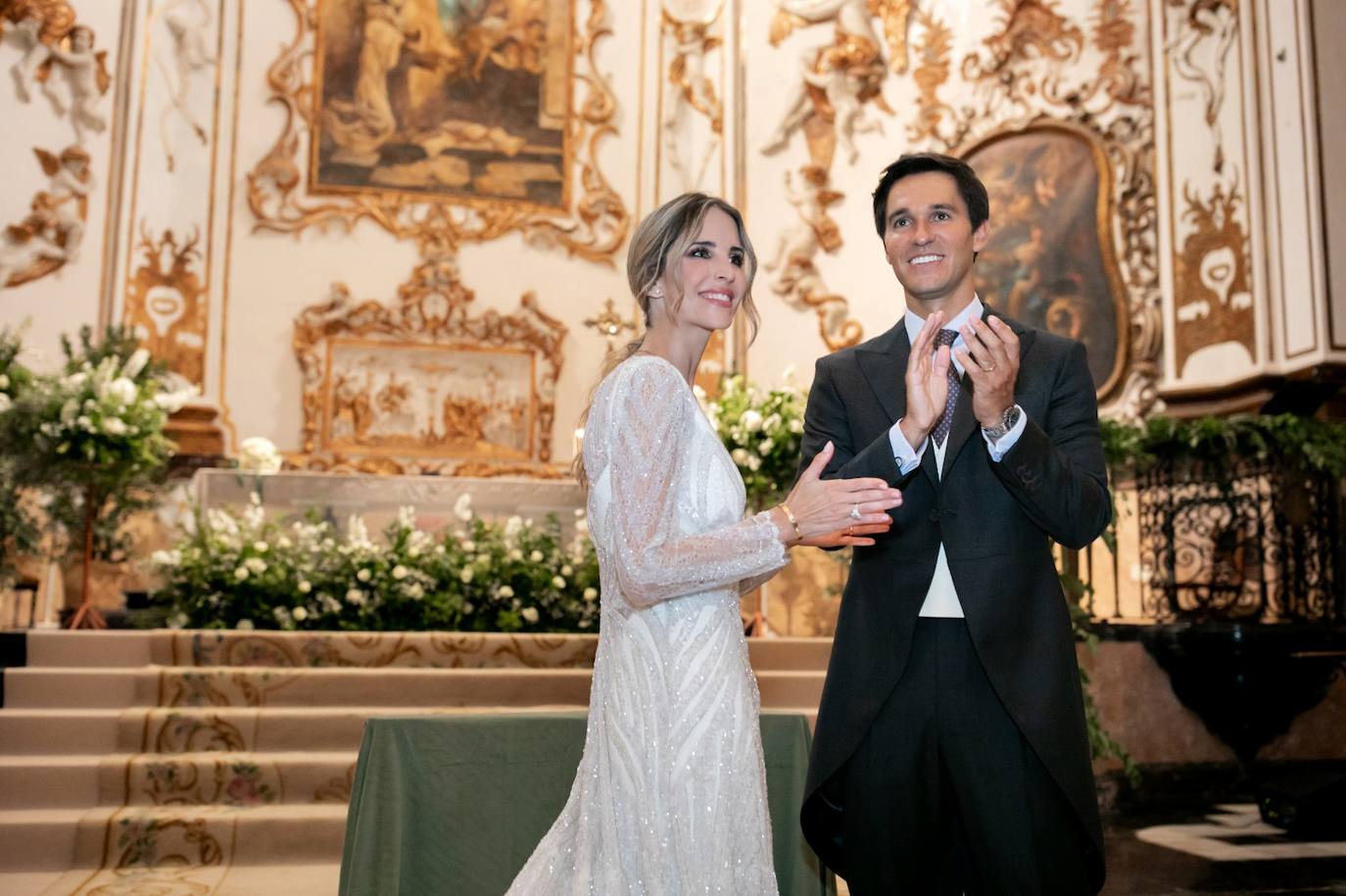 Nuria y Varis aplauden a los músicos. La iglesia de San Juan de la Cruz estaba decorada en verde y blanco, como el ramo de la novia.